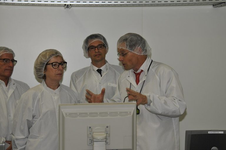 Semiconductor factory clean room with engineers producing computer chips